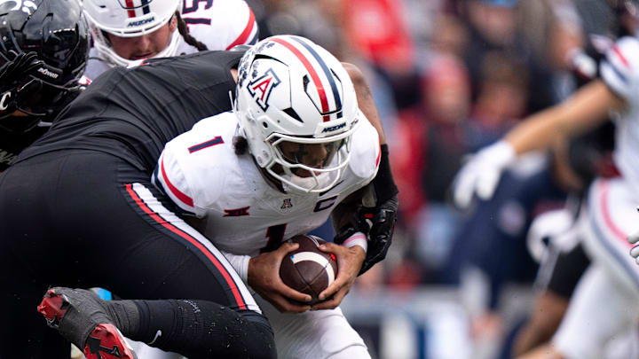 Cincinnati Bearcats defensive lineman Mikah Coleman (4) sacks Arizona Wildcats quarterback Noah Fifita (1) in the second quarter of the NCAA football game between the Cincinnati Bearcats and Arizona Wildcats at Nippert Stadium in Cincinnati on Nov. 15, 2025.