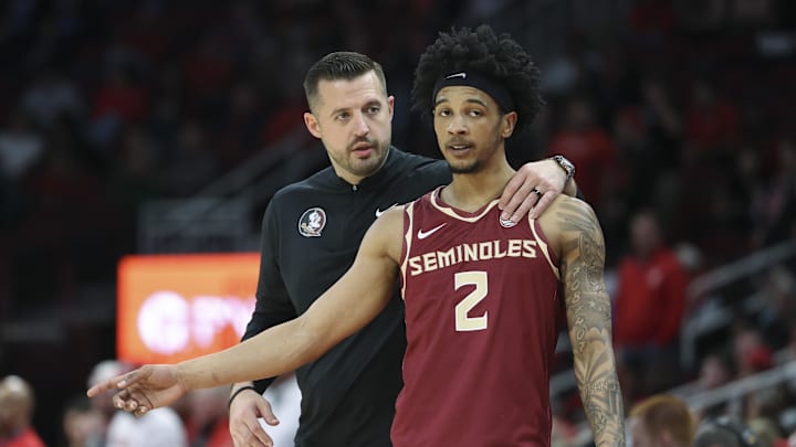Dec 5, 2025; Houston, Texas, USA; Florida State Seminoles head coach Luke Loucks talks with guard Cam Miles (2) during the first half against the Houston Cougars at Toyota Center. Mandatory Credit: Troy Taormina-Imagn Images Dec 5, 2025; Houston, Texas, USA; Florida State Seminoles head coach Luke Loucks talks with guard Cam Miles (2) during the first half against the Houston Cougars at Toyota Center. Mandatory Credit: Troy Taormina-Imagn Images