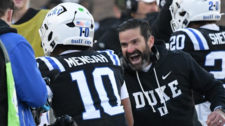 Nov 29, 2025; Durham, North Carolina, USA;  Duke Blue Devils head coach Manny Diaz celebrates Duke Blue Devils quarter back Darian Mensah's (10) touchdown against the Wake Forest Demon Deacons during the second quarter at Wallace Wade Stadium. Mandatory Credit: Zachary Taft-Imagn Images