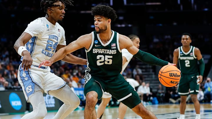 Michigan State forward Malik Hall (25) dribbles against North Carolina forward Jae'Lyn Withers (24) during the first half of the NCAA tournament West Region second round at Spectrum Center in Charlotte, N.C. on Saturday, March 23, 2024. Michigan State forward Malik Hall (25) dribbles against North Carolina forward Jae'Lyn Withers (24) during the first half of the NCAA tournament West Region second round at Spectrum Center in Charlotte, N.C. on Saturday, March 23, 2024.