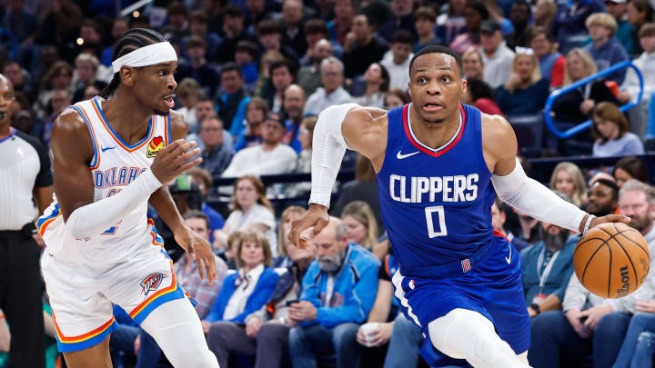 Dec 21, 2023; Oklahoma City, Oklahoma, USA;  LA Clippers guard Russell Westbrook (0) drives around Oklahoma City Thunder guard Shai Gilgeous-Alexander (2) during the second half at Paycom Center. Mandatory Credit: Alonzo Adams-USA TODAY Sports