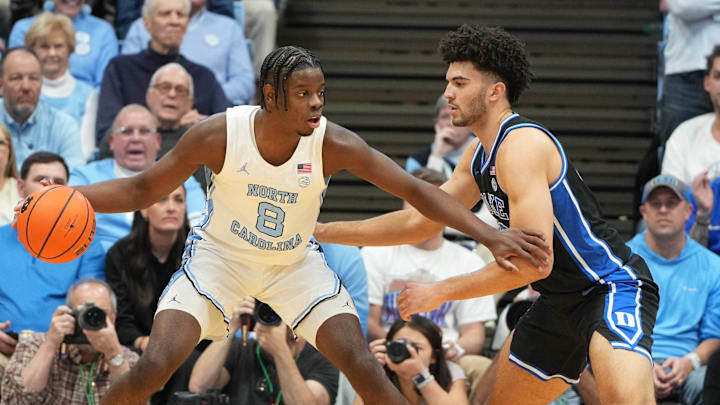 Feb 7, 2026; Chapel Hill, North Carolina, USA; North Carolina Tar Heels forward Caleb Wilson (8) with the ball as Duke Blue Devils forward Cameron Boozer (12) defends in the first half at Dean E. Smith Center. Mandatory Credit: Bob Donnan-Imagn Images Feb 7, 2026; Chapel Hill, North Carolina, USA; North Carolina Tar Heels forward Caleb Wilson (8) with the ball as Duke Blue Devils forward Cameron Boozer (12) defends in the first half at Dean E. Smith Center. Mandatory Credit: Bob Donnan-Imagn Images