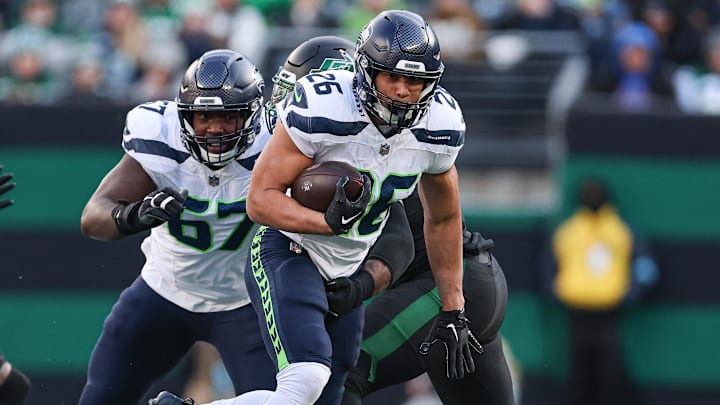 Dec 1, 2024; East Rutherford, New Jersey, USA; Seattle Seahawks running back Zach Charbonnet (26) carries the ball during the first half against the New York Jets at MetLife Stadium. Mandatory Credit: Vincent Carchietta-Imagn Images