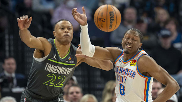 Feb 23, 2025; Minneapolis, Minnesota, USA; Minnesota Timberwolves guard Jaylen Clark (22) and Oklahoma City Thunder forward Jalen Williams (8) go after a loose ball in the first half at Target Center. Mandatory Credit: Jesse Johnson-Imagn Images