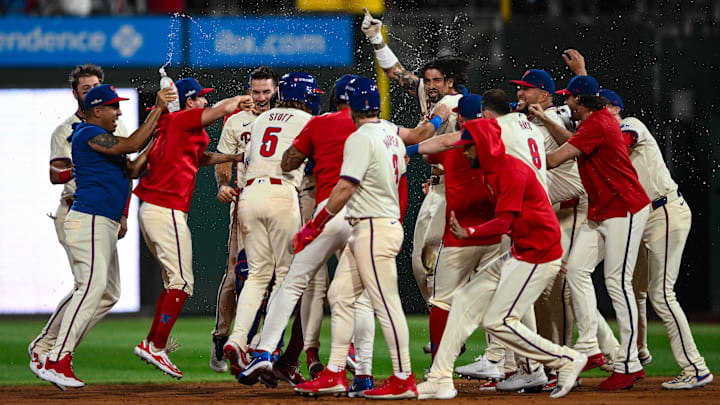 Oct 6, 2024; Philadelphia, Pennsylvania, USA; Philadelphia Phillies outfielder Nick Castellanos (8) celebrates with teammates after hitting a walk-off single against the New York Mets in the ninth inning during game two of the NLDS for the 2024 MLB Playoffs at Citizens Bank Park