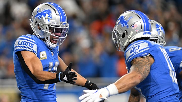 Detroit Lions wide receiver Amon-Ra St. Brown (14) celebrates with Detroit Lions running back Craig Reynolds (13) 
