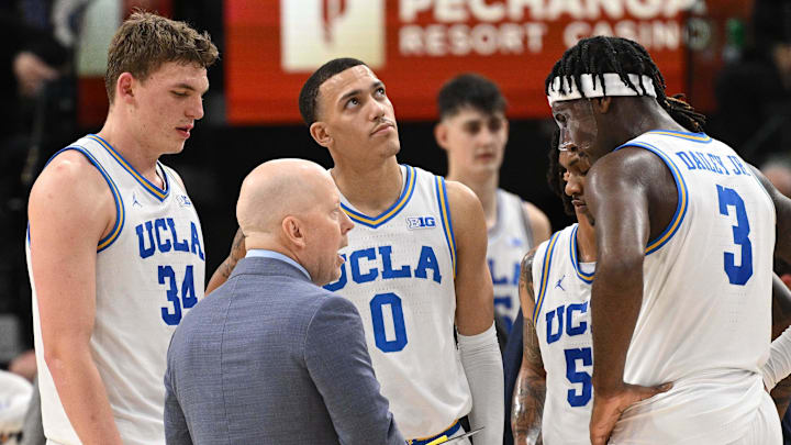 Dec 28, 2024; Inglewood, California, USA; UCLA Bruins head coach Mick Cronin talks to Tyler Bilodeau (34), Kobe Johnson (0), Dylan Andrews (2) and Eric Dailey Jr. (3) in the first half against the Gonzaga Bulldogs during a college basketball game at Intuit Dome. Mandatory Credit: Robert Hanashiro-Imagn Images