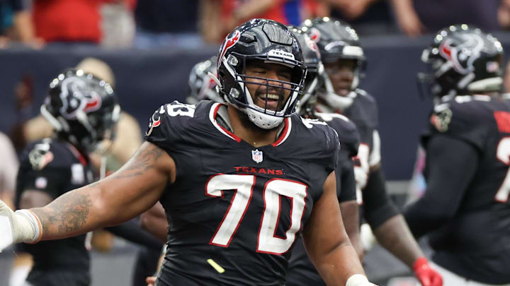 Sep 29, 2024; Houston, Texas, USA;  Houston Texans center Juice Scruggs (70) celebrates a Texans running back Dare Ogunbowale (33) touchdown against the Jacksonville Jaguars in the second half at NRG Stadium. Mandatory Credit: Thomas Shea-Imagn Images