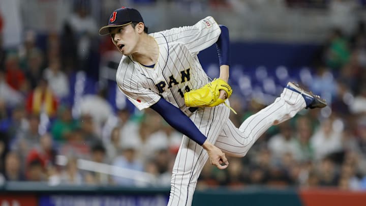 Mar 20, 2023; Miami, Florida, USA; Japan starting pitcher Roki Sasaki (14) delivers a pitch during the first inning against Mexico at LoanDepot Park