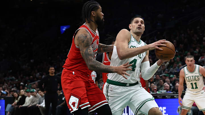 Feb 11, 2026; Boston, Massachusetts, USA; Boston Celtics center Nikola Vucevic (4) drives on Chicago Bulls center Nick Richards (13) during the first quarter at TD Garden. Mandatory Credit: Winslow Townson-Imagn Images