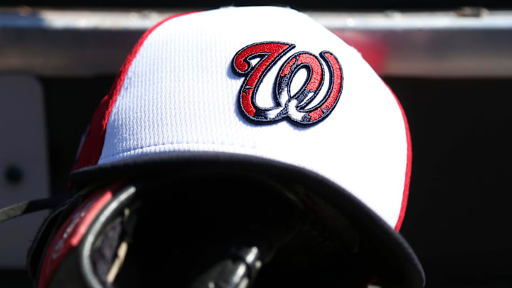 White Washington Nationals hat on top of a black mitt
