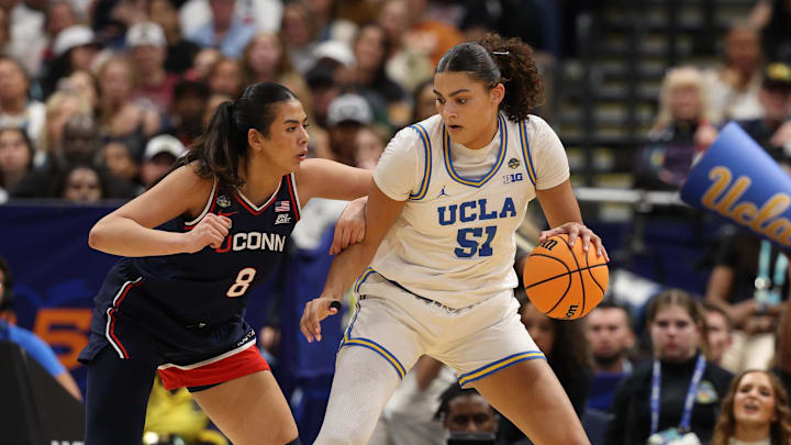 Apr 4, 2025; Tampa, FL, USA;  UCLA Bruins center Lauren Betts (51) dribbles against Connecticut Huskies center Jana El Alfy (8) during the third quarter in a semifinal of the women's 2025 NCAA tournament at Amalie Arena. Mandatory Credit: Nathan Ray Seebeck-Imagn Images