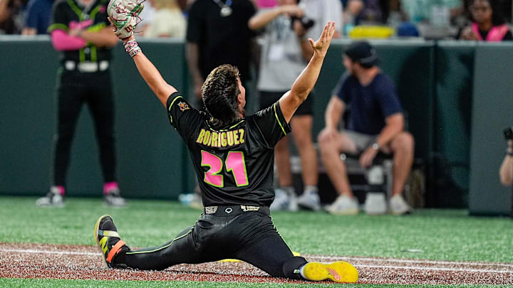 Jun 7, 2025; Charlotte, NC, USA; Party Animals pitcher Riyan Rodriguez (21) celebrates making a pop fly catch against the Savannah Bananas during the exhibition game at Bank of America Stadium. Mandatory Credit: Jim Dedmon-Imagn Images