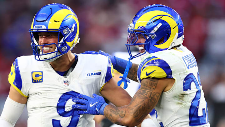 Dec 7, 2025; Glendale, Arizona, USA; Los Angeles Rams quarterback Matthew Stafford (9) reacts with running back Blake Corum (22) against the Arizona Cardinals during the second half at State Farm Stadium. Mandatory Credit: Mark J. Rebilas-Imagn Images Dec 7, 2025; Glendale, Arizona, USA; Los Angeles Rams quarterback Matthew Stafford (9) reacts with running back Blake Corum (22) against the Arizona Cardinals during the second half at State Farm Stadium. Mandatory Credit: Mark J. Rebilas-Imagn Images
