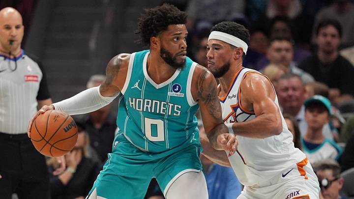 Apr 2, 2026; Charlotte, North Carolina, USA; Charlotte Hornets forward Miles Bridges (0) works the ball against Phoenix Suns guard Devin Booker (1)during the first quarter at Spectrum Center. Mandatory Credit: Jim Dedmon-Imagn Images Apr 2, 2026; Charlotte, North Carolina, USA; Charlotte Hornets forward Miles Bridges (0) works the ball against Phoenix Suns guard Devin Booker (1)during the first quarter at Spectrum Center. Mandatory Credit: Jim Dedmon-Imagn Images