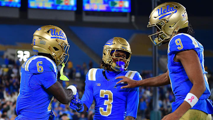 Nov 8, 2025; Pasadena, California, USA; UCLA Bruins running back Anthony Woods (6) celebrates his touchdown scored against the Nebraska Cornhuskers with wide receiver Kwazi Gilmer (3) and quarterback Nico Iamaleava (9) during the second half at the Rose Bowl. Mandatory Credit: Gary A. Vasquez-Imagn Images