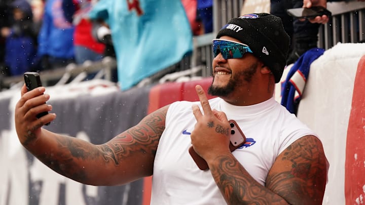 Dec 14, 2025; Foxborough, Massachusetts, USA; Buffalo Bills offensive tackle Dion Dawkins (73) take s a selfie with fans after warming up before the start of the game against the New England Patriots at Gillette Stadium. Dec 14, 2025; Foxborough, Massachusetts, USA; Buffalo Bills offensive tackle Dion Dawkins (73) take s a selfie with fans after warming up before the start of the game against the New England Patriots at Gillette Stadium.