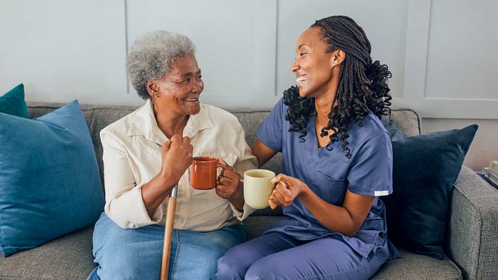 Senior woman and healthcare worker having happy conversation Senior woman and healthcare worker having happy conversation