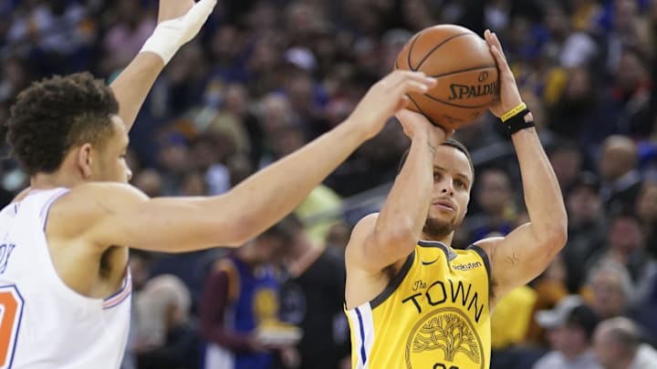 January 8, 2019; Oakland, CA, USA; Golden State Warriors guard Stephen Curry (30) shoots the basketball against New York Knicks forward Kevin Knox (20) during the third quarter at Oracle Arena. 