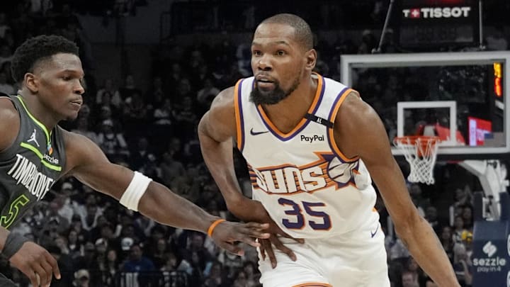 Mar 28, 2025; Minneapolis, Minnesota, USA; Phoenix Suns forward Kevin Durant (35) brings the ball up as Minnesota Timberwolves guard Anthony Edwards (5) defends him in the fourth quarter at Target Center. Mandatory Credit: Bruce Kluckhohn-Imagn Images