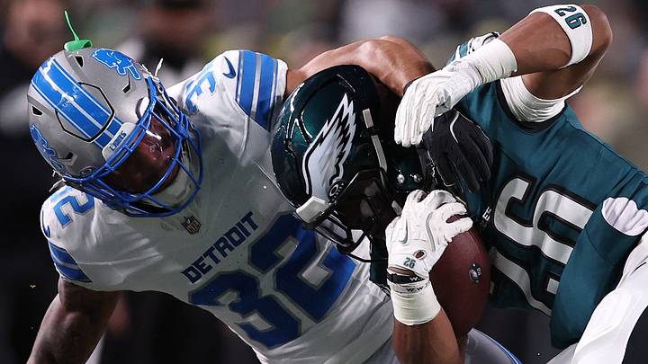 Detroit Lions safety Brian Branch (32) tackles Philadelphia Eagles running back Saquon Barkley (26) 