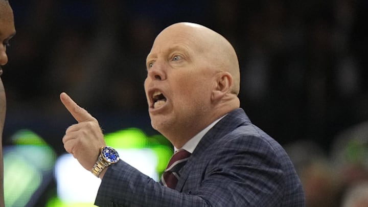 Jan 7, 2025; Los Angeles, California, USA; UCLA Bruins head coach Mick Cronin talks with guard Sebastian Mack (12) in the first half against the Michigan Wolverines at Pauley Pavilion presented by Wescom. Mandatory Credit: Kirby Lee-Imagn Images Jan 7, 2025; Los Angeles, California, USA; UCLA Bruins head coach Mick Cronin talks with guard Sebastian Mack (12) in the first half against the Michigan Wolverines at Pauley Pavilion presented by Wescom. Mandatory Credit: Kirby Lee-Imagn Images