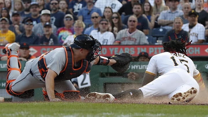 Jul 22, 2025; Pittsburgh, Pennsylvania, USA;  Pittsburgh Pirates center fielder Oneil Cruz (15) slides home past Detroit Tigers catcher Jake Rogers (34) to score on a Tigers error during the third inning at PNC Park.