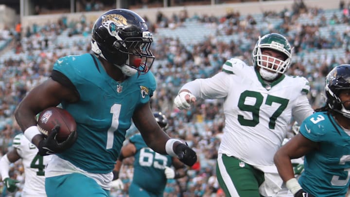 Dec 14, 2025; Jacksonville, Florida, USA; Jacksonville Jaguars running back Travis Etienne Jr. (1) runs to score a touchdown during the fourth quarter against the New York Jets at EverBank Stadium. Mandatory Credit: Morgan Tencza-Imagn Images