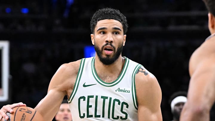 Mar 16, 2026; Boston, Massachusetts, USA; Boston Celtics forward Jayson Tatum (0) dribbles against Phoenix Suns forward Oso Ighodaro (11) during the second half at the TD Garden. Mandatory Credit: Brian Fluharty-Imagn Images