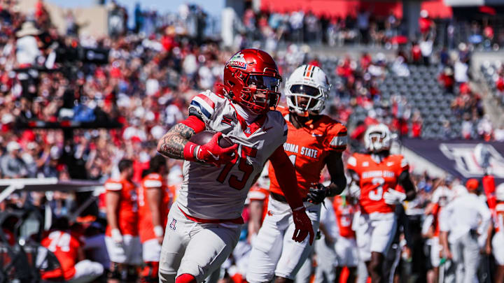 Oct 4, 2025; Tucson, Arizona, USA; Arizona Wildcats wide receiver Luke Wysong (15) scores a touchdown against the Oklahoma State Cowboys during the second quarter at Arizona Stadium. Mandatory Credit: Aryanna Frank-Imagn Images Oct 4, 2025; Tucson, Arizona, USA; Arizona Wildcats wide receiver Luke Wysong (15) scores a touchdown against the Oklahoma State Cowboys during the second quarter at Arizona Stadium. Mandatory Credit: Aryanna Frank-Imagn Images