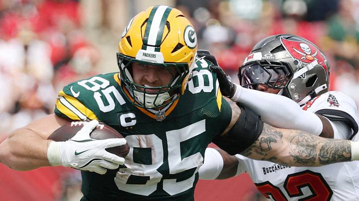Green Bay Packers tight end Tucker Kraft (85) is tackled by Tampa Bay Buccaneers defensive back Keionte Scott. Green Bay Packers tight end Tucker Kraft (85) is tackled by Tampa Bay Buccaneers defensive back Keionte Scott.