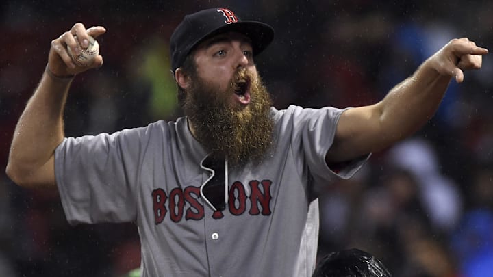 A Boston Red Sox fan reacts after getting a ball during the sixth inning in a game against the Red Sox and Seattle Mariners at Fenway Park.