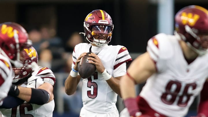 Jan 5, 2025; Arlington, Texas, USA; Washington Commanders quarterback Jayden Daniels (5) throws a pass against the Dallas Cowboys during the second quarter at AT&T Stadium. Mandatory Credit: Tim Heitman-Imagn Images