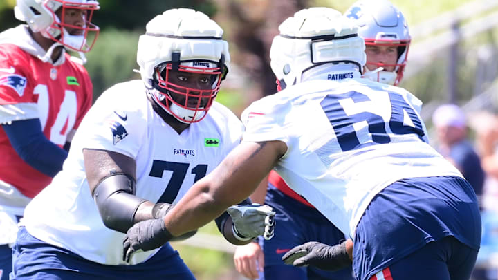 Jul 26, 2024; Foxborough, MA, USA; New England Patriots offensive tackle Mike Onwenu (71) works with offensive tackle Zuri Henry (65) during training camp at Gillette Stadium. Mandatory Credit: Eric Canha-Imagn Images