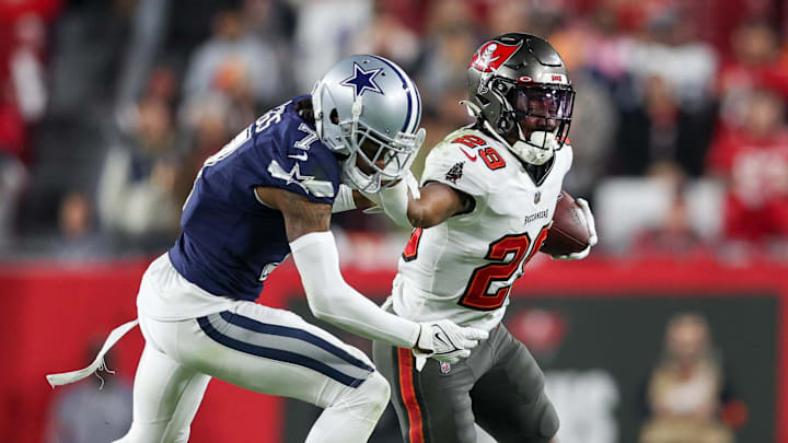 Jan 16, 2023; Tampa, Florida, USA; Tampa Bay Buccaneers running back Rachaad White (29) holds off Dallas Cowboys cornerback Trevon Diggs (7) in the fourth quarter during a wild card game at Raymond James Stadium. Mandatory Credit: Nathan Ray Seebeck-Imagn Images Jan 16, 2023; Tampa, Florida, USA; Tampa Bay Buccaneers running back Rachaad White (29) holds off Dallas Cowboys cornerback Trevon Diggs (7) in the fourth quarter during a wild card game at Raymond James Stadium. Mandatory Credit: Nathan Ray Seebeck-Imagn Images