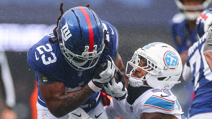 Sep 27, 2026; East Rutherford, New Jersey, USA; New York Giants running back Najee Harris (23) is tackled by Tennessee Titans safety Kevin Winston Jr. (23) during the first half at MetLife Stadium. Mandatory Credit: Vincent Carchietta-Imagn Images