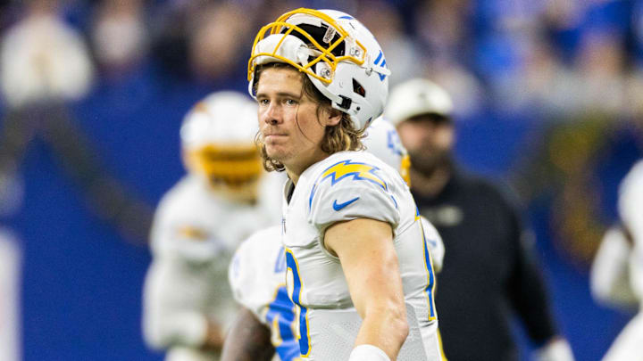 Dec 26, 2022; Indianapolis, Indiana, USA; Los Angeles Chargers quarterback Justin Herbert (10) congratulates the defense after a fourth down stop in the second half against the Indianapolis Colts at Lucas Oil Stadium. Mandatory Credit: Trevor Ruszkowski-Imagn Images