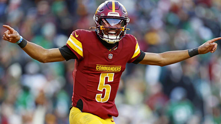 Dec 22, 2024; Landover, Maryland, USA; Washington Commanders quarterback Jayden Daniels (5) celebrates after throwing a touchdown during the fourth quarter against the Philadelphia Eagles at Northwest Stadium. Mandatory Credit: Peter Casey-Imagn Images