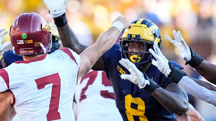 USC quarterback Miller Moss (7) makes a pass against Michigan defensive end Derrick Moore (8) during the second half at Michigan Stadium in Ann Arbor on Saturday, Sept. 21, 2024.
