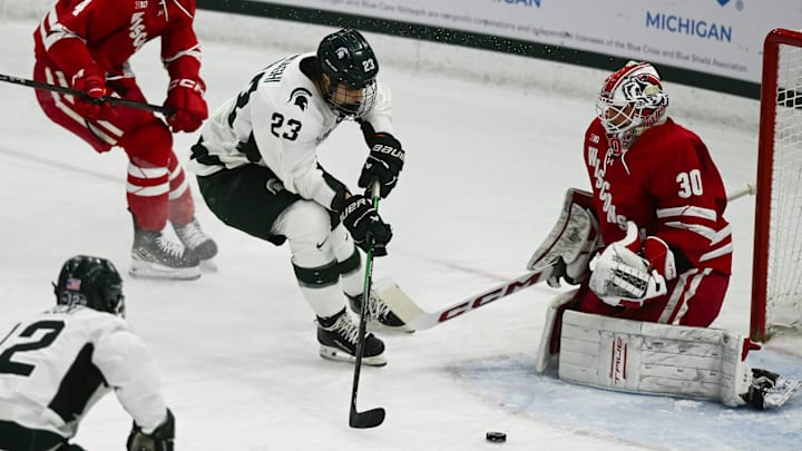 MSU's Shane Vansaghi shoots against Wisconsin goalie Wisconisn goalie Tommy Scarfone, Thursday, Jan. 2, 2024, at Munn Ice Arena. MSU won 4-3. MSU's Shane Vansaghi shoots against Wisconsin goalie Wisconisn goalie Tommy Scarfone, Thursday, Jan. 2, 2024, at Munn Ice Arena. MSU won 4-3.
