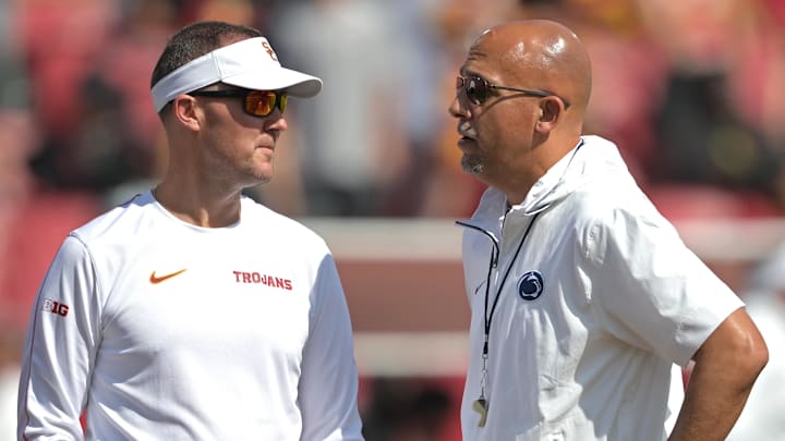Oct 12, 2024; Los Angeles, California, USA; USC Trojans head coach Lincoln Riley, left, talks with Penn State Nittany Lions head coach James Franklin on the field prior to the game at United Airlines Field at Los Angeles Memorial Coliseum. Mandatory Credit: Jayne Kamin-Oncea-Imagn Images