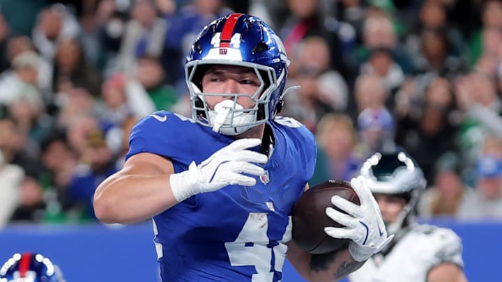 Oct 9, 2025; East Rutherford, New Jersey, USA; New York Giants running back Cam Skattebo (44) scores a touchdown against the Philadelphia Eagles during the second quarter at MetLife Stadium.  