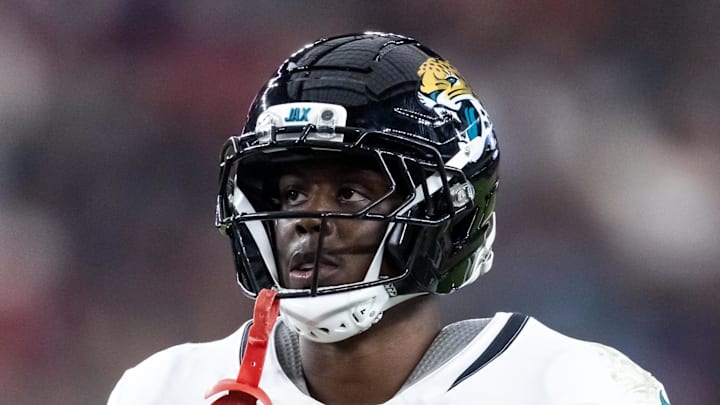 Nov 23, 2025; Glendale, Arizona, USA; Jacksonville Jaguars running back Travis Etienne Jr. (1) against the Arizona Cardinals at State Farm Stadium. Mandatory Credit: Mark J. Rebilas-Imagn Images