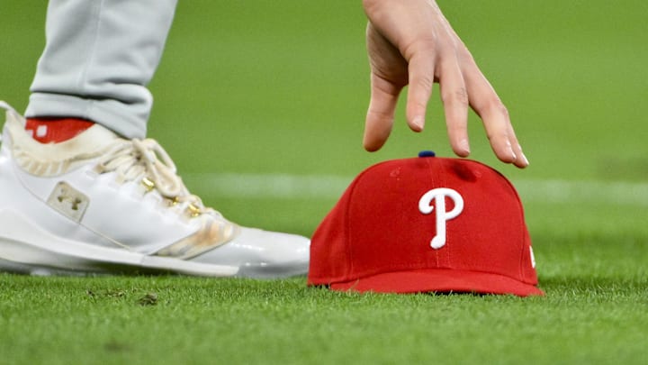 Apr 11, 2025; St. Louis, Missouri, USA;  Philadelphia Phillies third baseman Alec Bohm (28) picks up his hat after chasing down a fly ball against the St. Louis Cardinals during the third inning at Busch Stadium. Mandatory Credit: Jeff Curry-Imagn Images