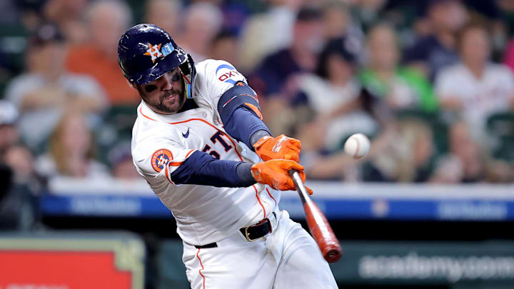 Houston Astros center fielder Chas McCormick (20) hits a single against the Colorado Rockies during the second inning at Daikin Park.