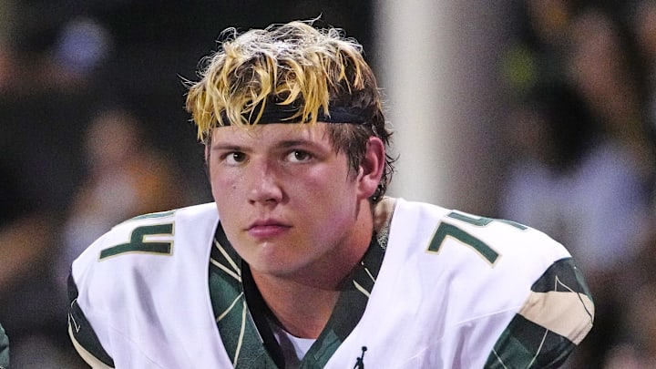 Basha tackles Dajohn Yarborough (75) and Jake Hildebrand (74) sit on the bench after another rushing touchdown against Brophy Prep during a game at Central High School in Phoenix on Aug. 28, 2025.