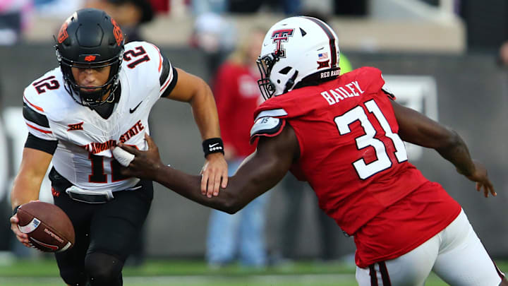 Oct 25, 2025; Lubbock, Texas, USA; Texas Tech Red Raiders defensive end David Bailey (31) pressures Oklahoma State Cowboys quarterback Noah Walters (12) in the second half at Jones AT&T Stadium. Mandatory Credit: Michael C. Johnson-Imagn Images Oct 25, 2025; Lubbock, Texas, USA; Texas Tech Red Raiders defensive end David Bailey (31) pressures Oklahoma State Cowboys quarterback Noah Walters (12) in the second half at Jones AT&T Stadium. Mandatory Credit: Michael C. Johnson-Imagn Images