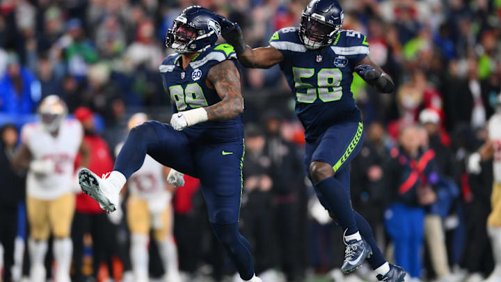 Seattle Seahawks DE Leonard Williams and LB Derick Hall react after the sack of San Francisco 49ers quarterback Brock Purdy.