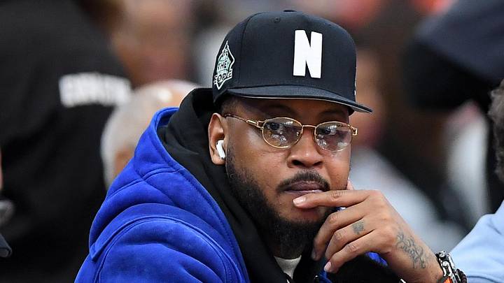 Jan 24, 2026; Syracuse, New York, USA; Hall of fame member Carmelo Anthony (center) looks on during the second half of the game between the Miami Hurricanes and the Syracuse Orange at the JMA Wireless Dome. Mandatory Credit: Rich Barnes-Imagn Images