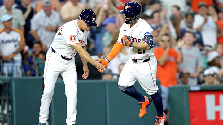 May 22, 2025; Houston, Texas, USA; Houston Astros left fielder Jose Altuve (27) shakes hands with Houston Astros third base coach Tony Perezchica (12) after hitting a two run home run against the Seattle Mariners during the sixth inning at Daikin Park.